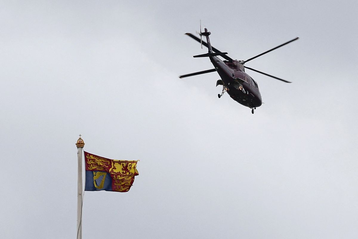 <p>Here, the King's Helicopter is pictured flying above a Royal Standard flag, as it takes off from the grounds of Buckingham Palace.</p>