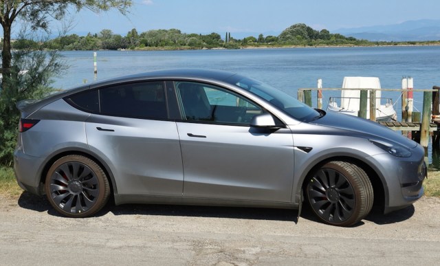 tesla model y owner turns heads with one-of-a-kind custom modification: ‘i can charge anywhere in the world’