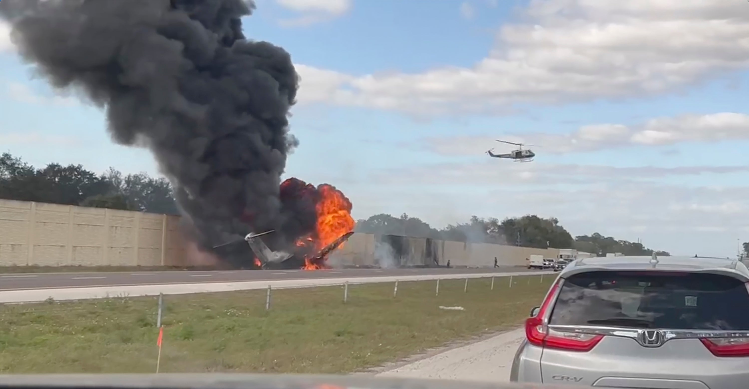two dead after plane crashes into florida motorway, with survivors seen fleeing from fireball