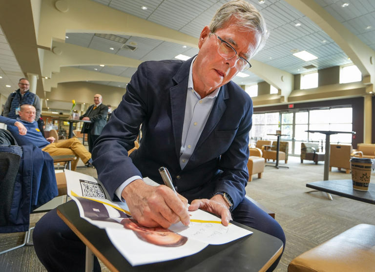 Jeb Bush, Florida's 43rd governor, signs an autograph for Dennis Smith prior to his speech to students during an afternoon class Thursday, April 7, 2022, at UW-Milwaukee at Waukesha. Mjs 04072022 Jebbush Ec01332