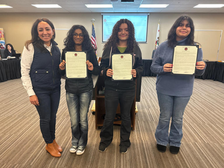 Woodland Joint Unified School District Board of Trustees Vice President Deborah Bautista Zavala presents essay contest winners Sri Vaddella, Melanie Salazar and Kaylee Kacho with a board resolution in support of Martin Luther King Jr. Day in Jan.. (Courtesy)