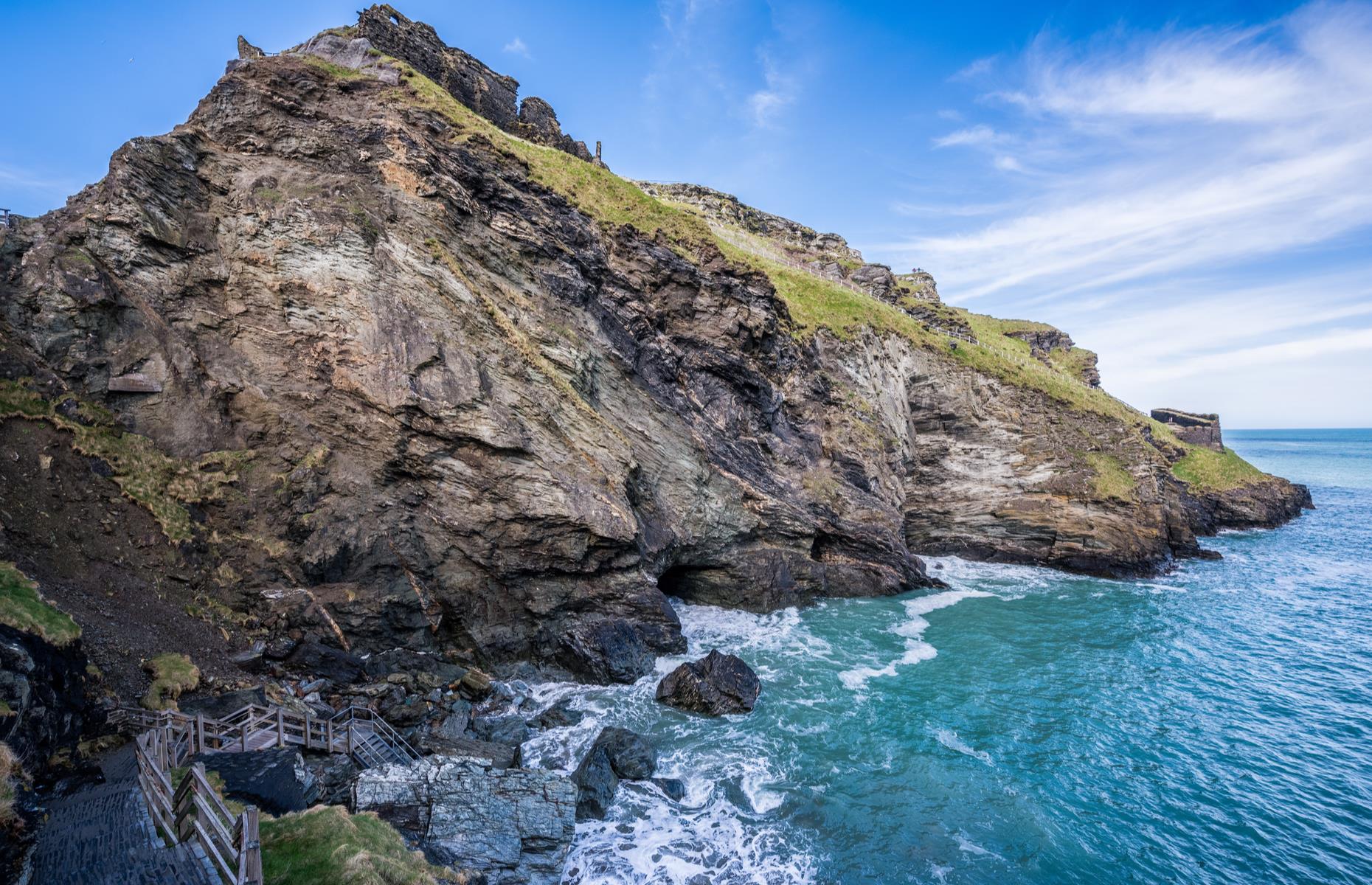 <p>The existence of the so-called “once and future king” is questionable, but the legend has captured imaginations since the Middle Ages. Tintagel’s association with Arthurian legends is thought to have inspired Richard, Earl of Cornwall to build a castle here in 1230. A rocky inlet below the castle, meanwhile, has been known as Merlin’s Cave since Victorian poet Alfred Tennyson's retelling of the legend, in which Merlin used a passageway below the castle to carry away the infant Arthur.</p>