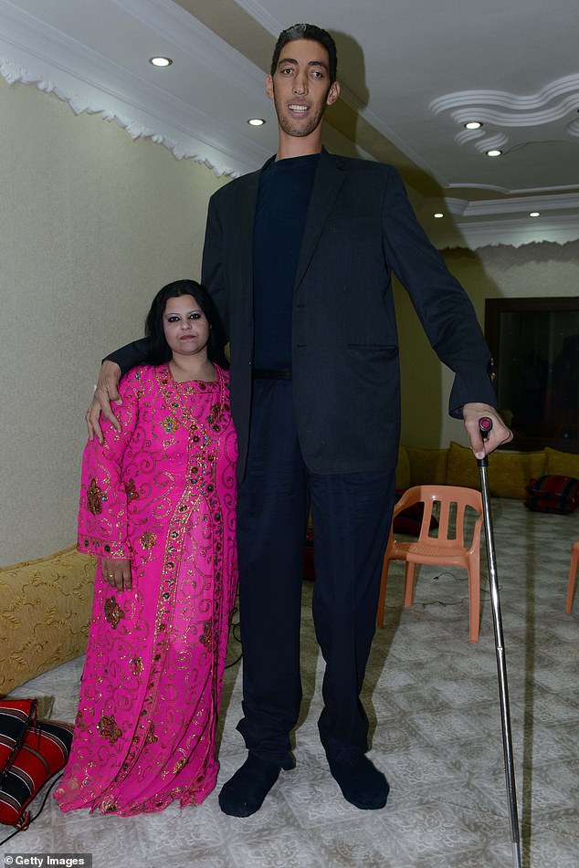 inside the life of the world's tallest man: how 8ft 3ins turkish giant sultan kosen, 41, married syrian woman 2ft 7in shorter than him only to divorce her over 'language barrier'... and now he travels the world looking for love