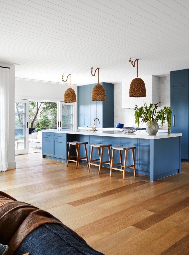 a refreshing and bold blue colour palette ties this home to its coastal locale