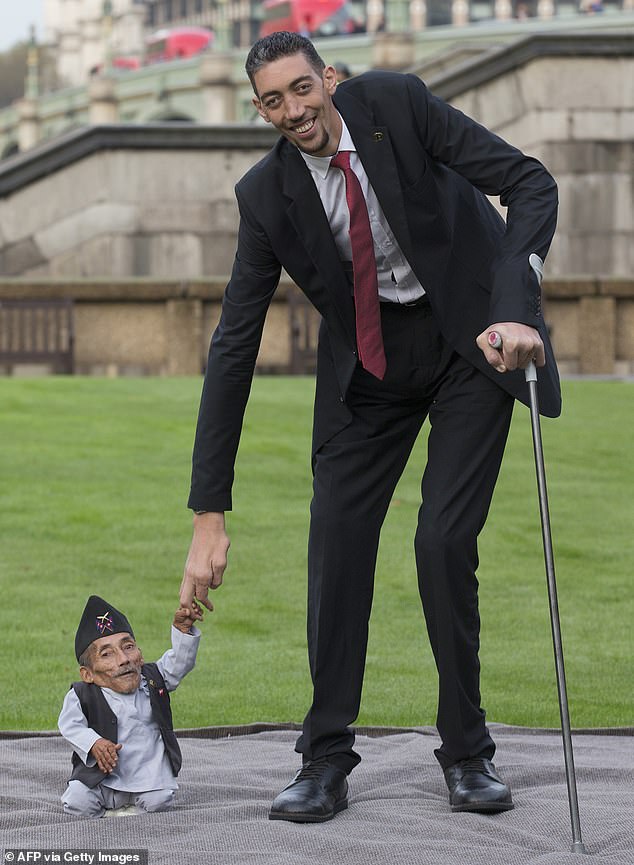 inside the life of the world's tallest man: how 8ft 3ins turkish giant sultan kosen, 41, married syrian woman 2ft 7in shorter than him only to divorce her over 'language barrier'... and now he travels the world looking for love