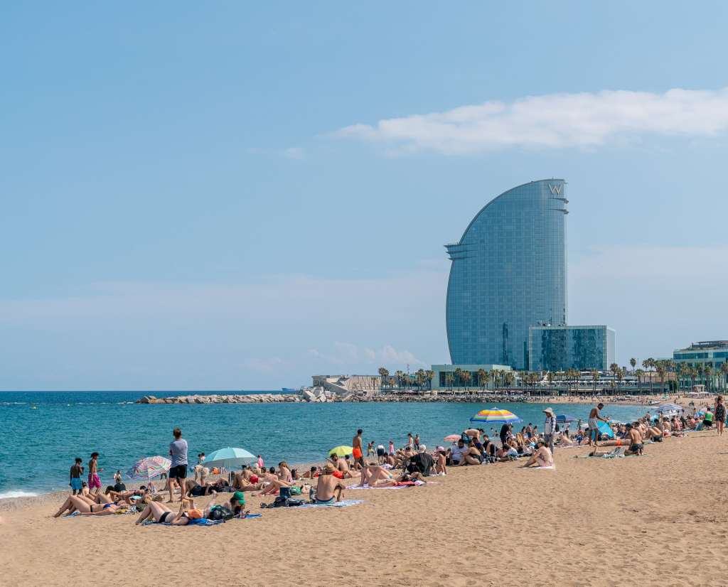 <p>Relax and unwind on the beautiful beaches of Barcelona, where you can bask in the sun and take refreshing dips in the Mediterranean Sea. Treat yourself to delicious seafood at one of the beachfront restaurants.</p><p>Tip: For a less crowded and more budget-friendly beach experience, consider visiting Sitges or Costa Brava.</p><p>Starting from the center and moving outward, here’s a rundown of Barcelona’s beaches:</p><ol> <li><strong>Barceloneta Beach</strong>: Arguably the most famous beach in Barcelona, although it can get quite crowded in the summer.</li> <li><strong>Nova Icaria Beach</strong>: A quieter option near Barceloneta, featuring facilities such as toilets and changing rooms.</li> <li><strong>Bogatell Beach</strong>: Known for its beach bars (chiringuitos), sunbeds, and umbrellas. It offers amenities like beach volley zones, and it’s typically less crowded. Showers and toilets are available.</li> <li><strong>Mar Bella Beach</strong>: This beach allows optional clothing. There are beach volleyball courts, a skate park, and nearby restaurants, although there’s no lifeguard on duty.</li> </ol><p class="has-text-align-center has-medium-font-size">Read also: <a href="https://worldwildschooling.com/hidden-beaches-in-europe/">Hidden Beaches in Europe</a></p>