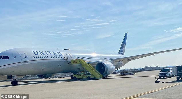 united flight from newark to los angeles diverts to chicago after suspicious bag and note are found in bathroom saying aircraft was going to 'blow up'