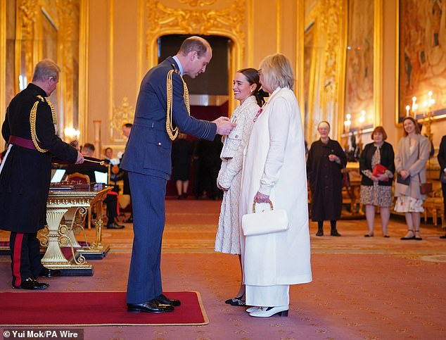 games of thrones star emilia clarke is joined by her mother as she's given gong by prince william at windsor castle for setting up brain injury charity - as spoons boss tim martin and sajid javid are knighted