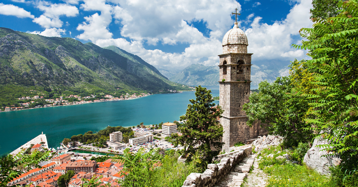 <p> With its stunning backdrop of imposing gray mountains that plunge into the narrow inlet of the shimmering Adriatic Sea, Montenegro’s fortified city of Kotor is guaranteed to leave an impression.  </p> <p> The old squares with modern cafes and boutiques, narrow cobblestone alleys, a maze of medieval churches and cathedrals, and the magnificent fortress of San Giovanni high above the town are just a few reasons Kotor needs to make it onto your travel bucket list.</p>