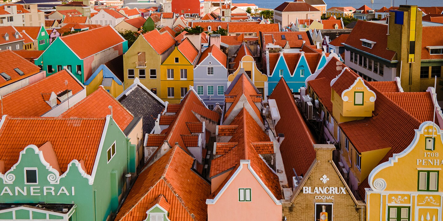 <p>You’ll feel transported to the Netherlands on a walk through Curaçao’s capital city of Willemstad.</p><p>Photo by fokke baarssen/Shutterstock</p><p>Welcome to Curaçao—or, as local residents say, Bon Bini. On this Southern Caribbean island, sunny skies and <a class="Link" href="https://www.afar.com/magazine/best-beaches-in-curacao" rel="noopener">blue waters abound</a>, and as one of the western-most islands of the Leeward Antilles, Curaçao offers balmy temperatures year-round (between the mid-70s and mid-80s Fahrenheit) and has very few <a class="Link" href="https://www.afar.com/magazine/6-things-to-know-about-visiting-the-caribbean-during-hurricane-season" rel="noopener">hurricanes</a>. </p><p>It’s a beach lover’s dream, with some <a class="Link" href="https://www.afar.com/magazine/best-beaches-in-curacao" rel="noopener">38 beaches</a> to choose from. At these sandy spots, visitors can couple a lazy few hours with a range of other activities, including snorkeling, cliff jumping, and cave swimming. But there’s more to experience in Curaçao than warm weather and beaches—taking a deeper dive into history rooted in the trans-Atlantic slave trade, for example, or sampling local food while roaming the captivating capital city, Willemstad. Here are the best things to do in Curaçao, including art, culture, and outdoor activities.</p><p>Vibrant historic buildings line the waterfront on the Punda side of Queen Emma Bridge.</p><p>Photo by Z. Jacobs/Shutterstock</p>