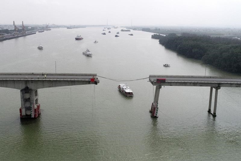 container ship hits bridge in south china, killing 2 and knocking section of roadway into the water