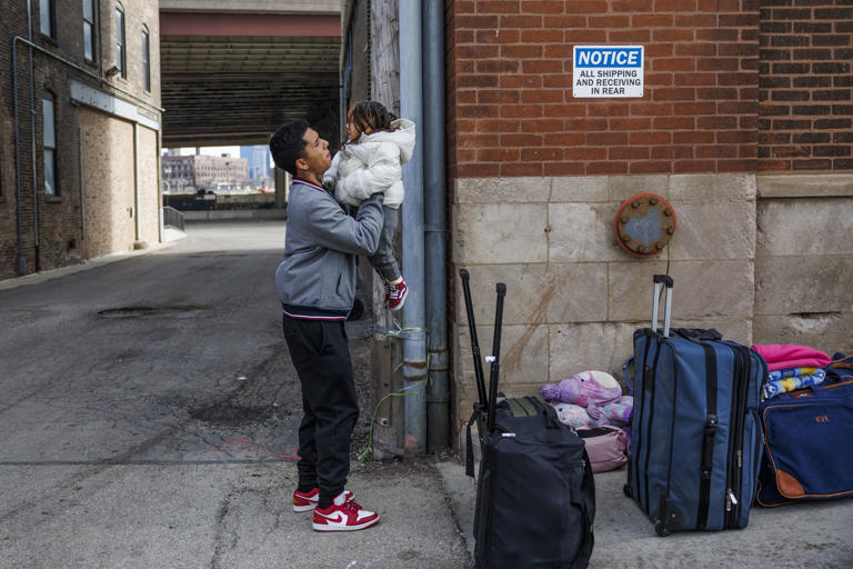 Moises Sanchez, 24, picks up his daughter Antonella Sanchez, 2, both from Venezuela, before leaving a Lower West Side shelter on Feb. 13, 2024. The family had been in Chicago for four months and was leaving to meet family in El Paso, Texas.
