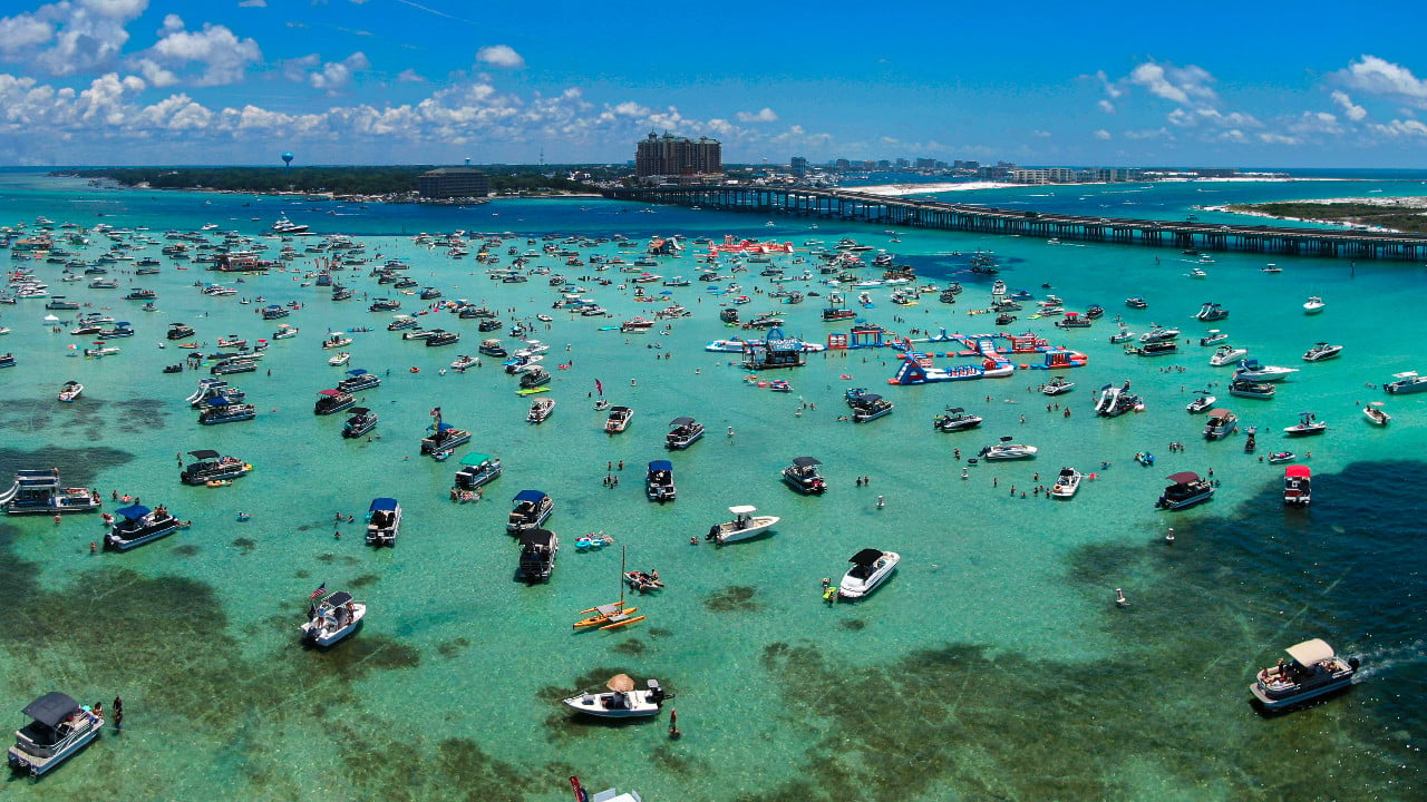 <p>You may have been to <a href="https://wealthofgeeks.com/best-beaches-in-florida/" rel="noopener">Florida beaches</a>, but have you been to a sand bar? Crab Island is one of the most popular tourist attractions in Destin. It’s a famous sand bar people drive their boats to and many stay on the sand bar all day. The water depth varies from 1-4 feet deep, and the only way to access Crab Island is by boat. Watch for dolphins and see the various animals that visit Crab Island depending on the tide. </p>