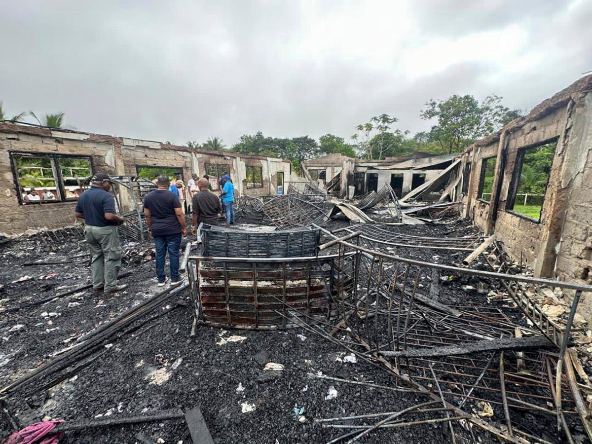 parents of two girls who survived a dorm fire that killed 20 in guyana sue the government