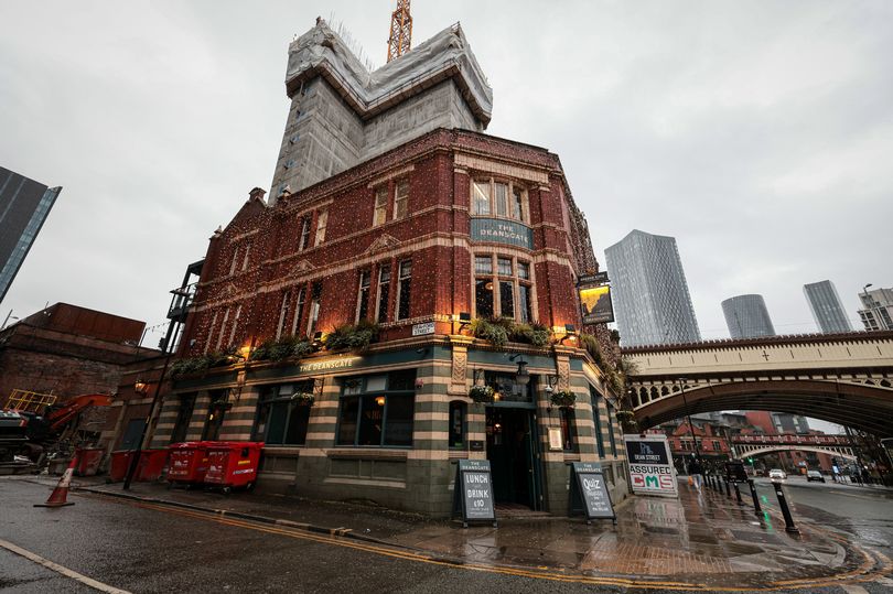 once a suntrap... now this historic manchester pub has been left in the shadow of a new skyscraper