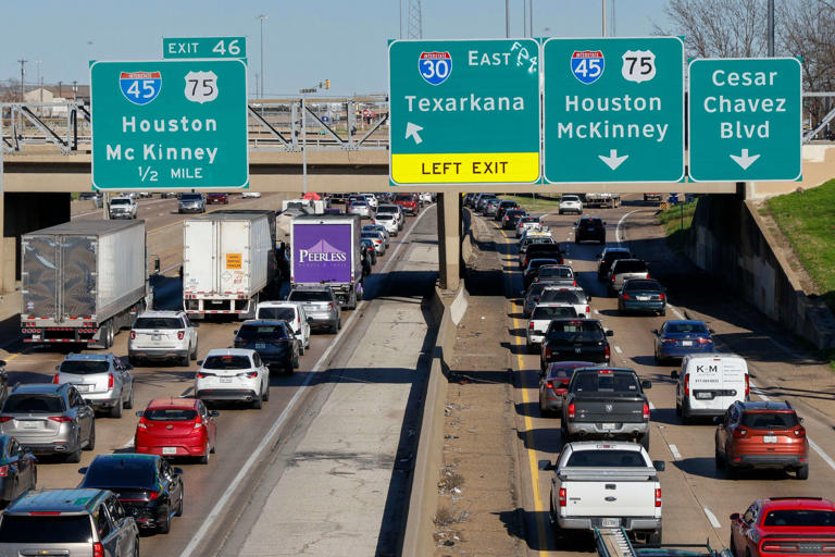 Semi-trucks drive slowly in traffic along Interstate 30 near the exit for Interstate 45 and U.S. 75, Tuesday, Feb. 13, 2024, in Dallas.