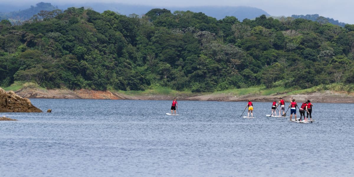 <p>La Fortuna may not present both <a href="https://letsjetkids.com/costa-rica-beach-and-jungle/" rel="noreferrer noopener">beach and jungle</a>, but it <em>is</em> home to an incredible lake, giving you some calm water activity options.</p><p>Lake Arenal is a beautiful doormat to the popular Arenal Volcano. If you want a relaxing adventure, rent a <a href="https://viator.tp.st/DfQajgBg" rel="noreferrer noopener nofollow sponsored">stand-up paddleboard, or take a tour</a>, and get out on the water for a day.  </p><p>The mountains surrounding the lake are covered in rainforests, and you’ll have stunning views of the Arenal Volcano. This will easily become the most beautiful place you’ve ever gone paddle boarding.  </p><p>Just because you’re not in the middle of a jungle doesn’t mean you won’t encounter wildlife. Watch for Blue Herons and Toucans above and Machacha and Rainbow Bass below as you enjoy the water.</p>