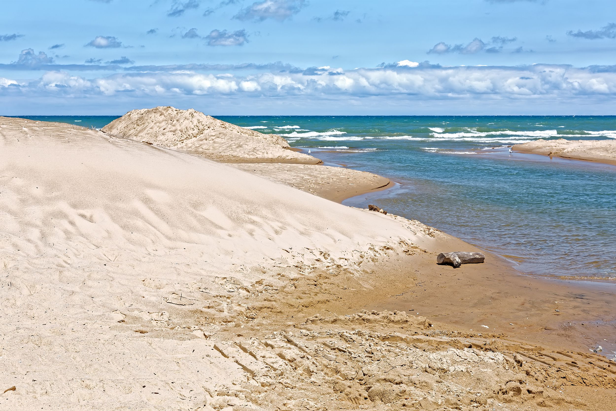 <p>A natural wonder created by glacial sand from the east and west sides of a 300-mile Lake Michigan, the Indiana Dunes have been carved over time by wind and waves nearly as powerful as those generated by an ocean. The <a href="https://www.nps.gov/indu/index.htm">15,000-acre park</a> is home to rare birds, sandy beach, and 50 miles of trails that wind through rugged dunes, wetlands, prairies, and forests. </p>