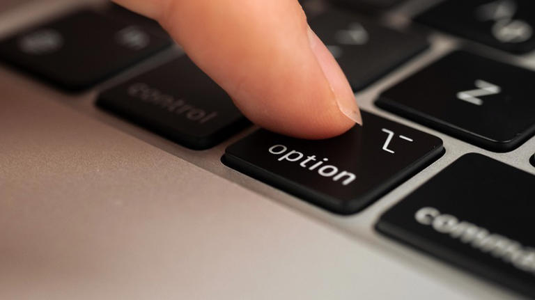 Finger pressing the Option key on Mac
