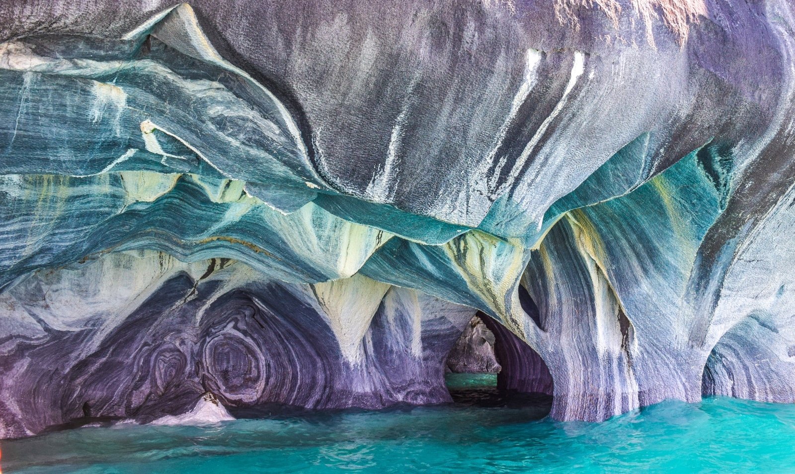 <p><span>The Marble Caves on Lake General Carrera are a breathtaking natural formation. Millennia of waves washing against calcium carbonate have sculpted these caves into stunning formations. The caves’ walls, with their swirling patterns of blue and grey, are a photographer’s dream, especially when reflected in the lake’s azure waters. Accessible only by boat, the caves offer a serene and otherworldly experience.</span></p> <p><b>Insider’s Tip: </b><span>Take a boat or kayak tour for the best views of the caves.</span></p> <p><b>When To Travel: </b><span>Visit between September and February for the best weather.</span></p> <p><b>How To Get There: </b><span>Fly to Balmaceda, then drive to Puerto Río Tranquilo, where tours to the caves are available.</span></p>