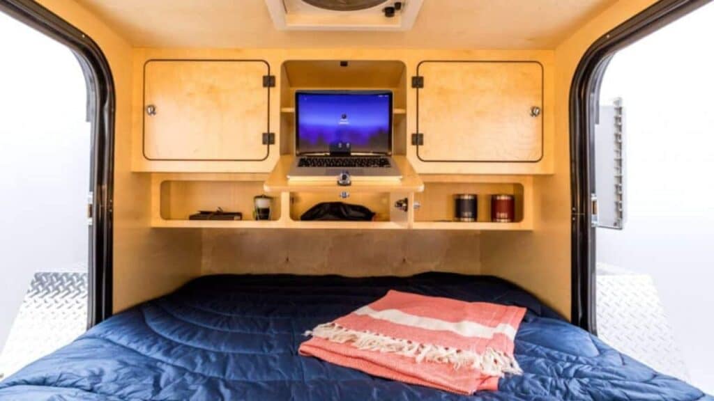 <p>The <a href="https://escapod.us/trailers/topo-series" rel="noopener">Escapod Topo Series</a> teardrop campers are made for exploring the rugged outdoors. This teardrop camper interior offers four cabinets, two cubbies, and a closed compartment behind the bed for your storage needs.</p><p>Relax on your queen bed with 5″ memory foam and peer out the stargazer window overhead. You’ll stay comfortable in this teardrop trailer interior with its 4-speed exhaust fan.</p><p>The outdoor galley is ready for gourmet cooking wherever you are. There’s a two-burner stove, counter space for food prep and a YETI Tundra 65 cooler.</p>