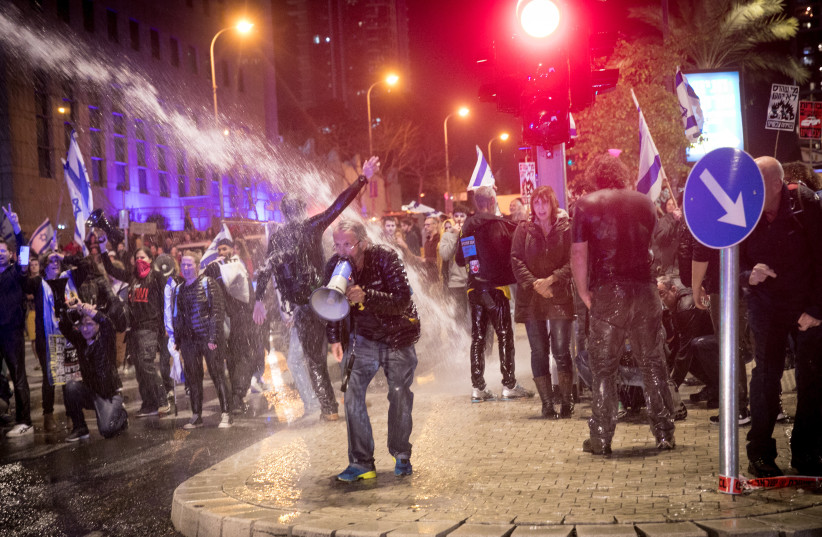former hostage and family face police brutality, hit by water cannon at tel aviv demonstration