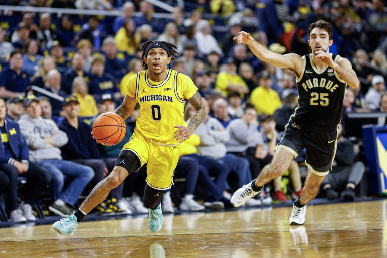 Dug McDaniel of the Michigan Wolverines dribbles up the court against Ethan Morton of the Purdue Boilermakers in the first half of a game at Crisler Arena on Sunday, Feb. 25, 2024, in Ann Arbor, Michigan.