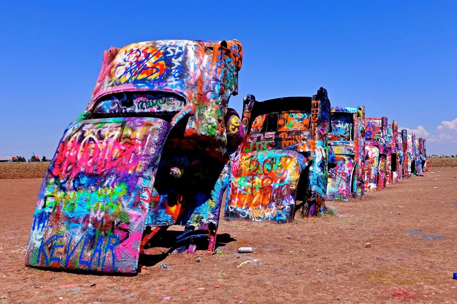<p><span>Cadillac Ranch, an iconic art installation near Amarillo, Texas, is a striking tribute to the evolution of the Cadillac tail fin. Ten Cadillac cars are half-buried nose-first in the ground, with their tail fins pointing skyward. </span><span>Created in 1974 by a group of artists known as The Ant Farm, the installation has become a symbol of American pop culture.</span></p> <p><span>Visitors are encouraged to leave their mark on the cars with spray paint, making it an interactive art piece. It’s a must-see for those interested in Americana and public art.</span></p> <p><b>Insider’s Tip: </b><span>Bring your own spray paint to contribute to this ever-changing art piece.</span></p> <p><b>When To Travel: </b><span>Accessible year-round, but spring and fall offer the most pleasant weather.</span></p> <p><b>How To Get There: </b><span>Located along I-40 just west of Amarillo.</span></p>