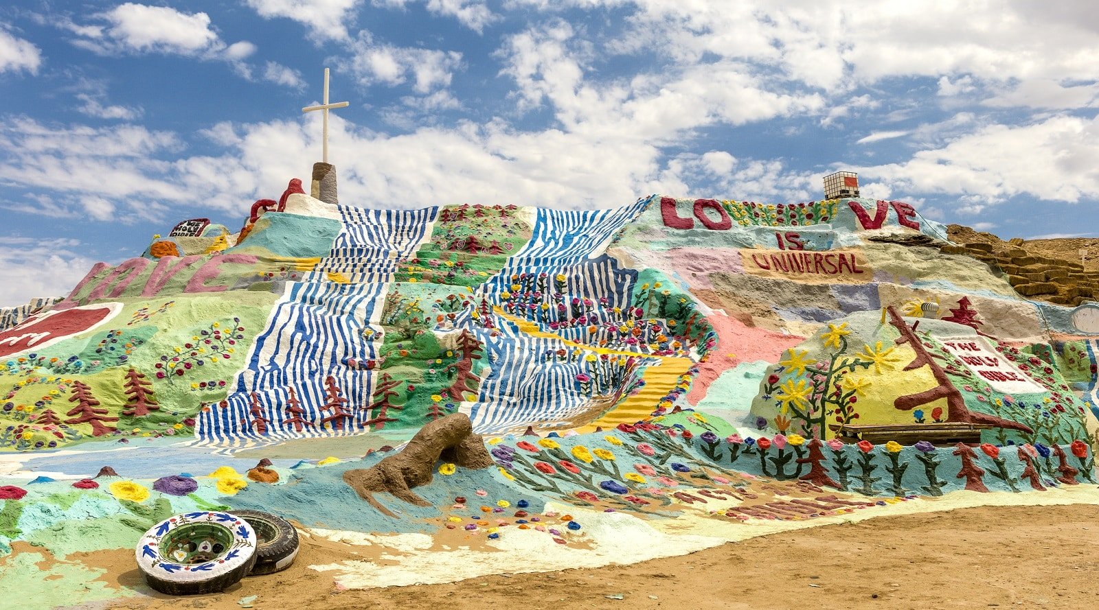 <p><span>Salvation Mountain, near Niland, California, is a vibrant pilgrimage to one man’s devotion and artistic vision. Leonard Knight created this folk art monument covered in colorful biblical and inspirational messages. Made from adobe, straw, and thousands of gallons of lead-free paint, it uniquely expresses faith and creativity.</span></p> <p><span>With its bright colors and simple yet powerful messages, the mountain offers a visually stunning and thought-provoking experience. It’s a must-visit for art enthusiasts and those seeking a place of peace and positivity.</span></p> <p><b>Insider’s Tip: </b><span>Bring plenty of water and sunscreen, as the area can get very hot.</span></p> <p><b>When To Travel: </b><span>Visit in the cooler months from November to March.</span></p> <p><b>How To Get There: </b><span>It’s located in the lower desert of Southern California in Imperial County and accessible via Beal Road.</span></p>