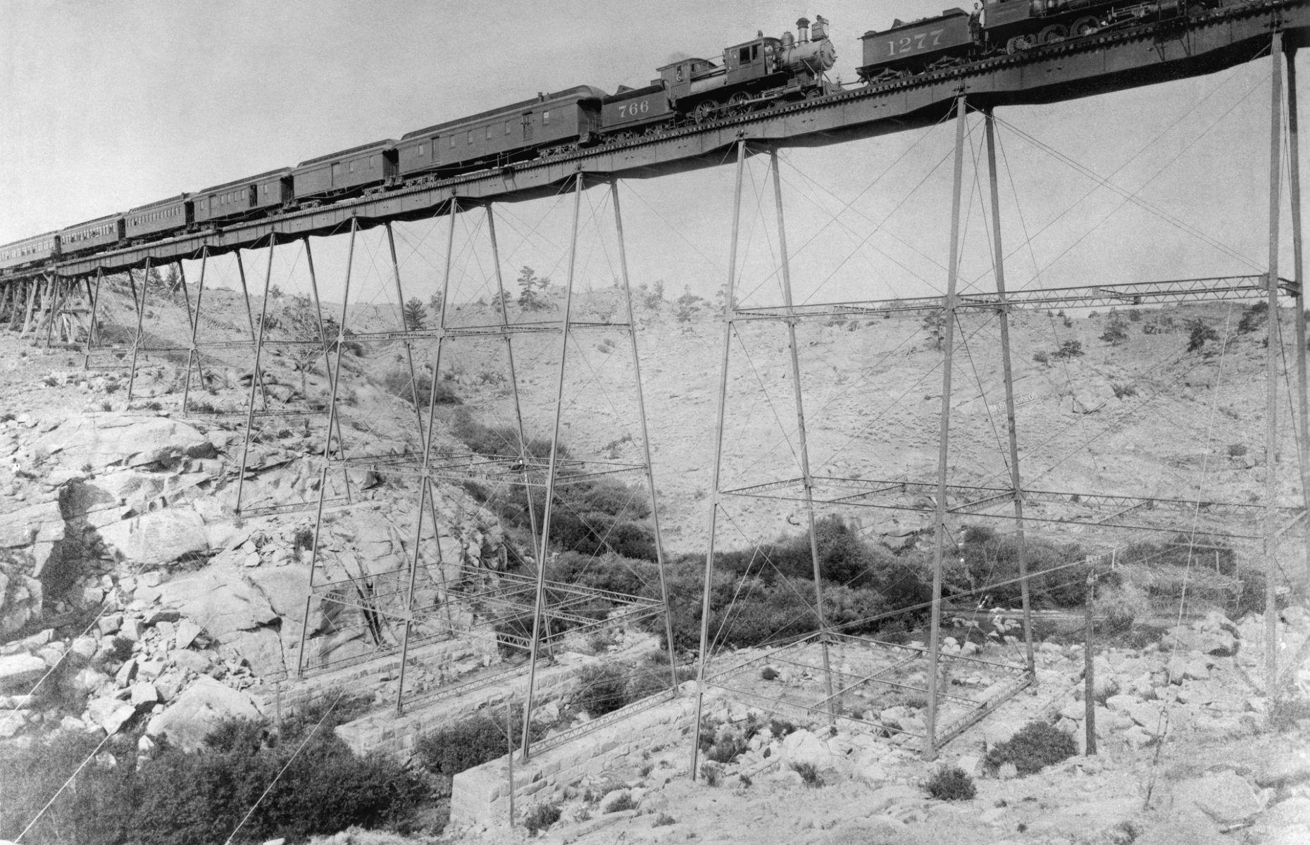 <p>When the Union Pacific Railroad reached the seemingly impassable Dale Creek, Wyoming in 1868, they initially breached the gap with a wooden trestle bridge – but it was a rickety structure. Two carpenters fell from the bridge to their deaths, and it swayed alarmingly when trains passed over it. In 1876 the original crossing was replaced by an iron bridge, pictured here in 1885. The spindly legs did a much better job of holding up the tracks, although trains still had to slow to 4 miles per hour when crossing.</p>