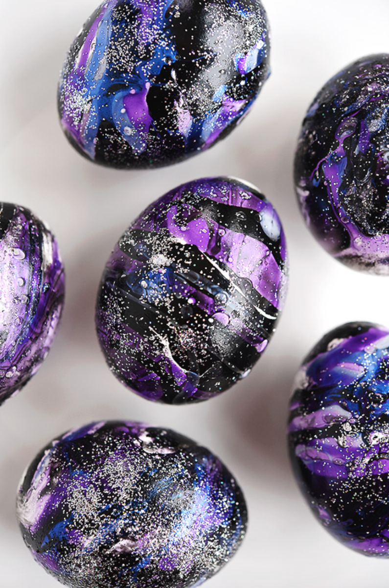 <p>This one is for all the space fans out there! Use black, blue, and purple nail polish to create these glittering galaxy eggs. </p><p><strong>Get the tutorial at <a href="https://onelittleproject.com/galaxy-easter-eggs/">One Little Project</a>. </strong></p>