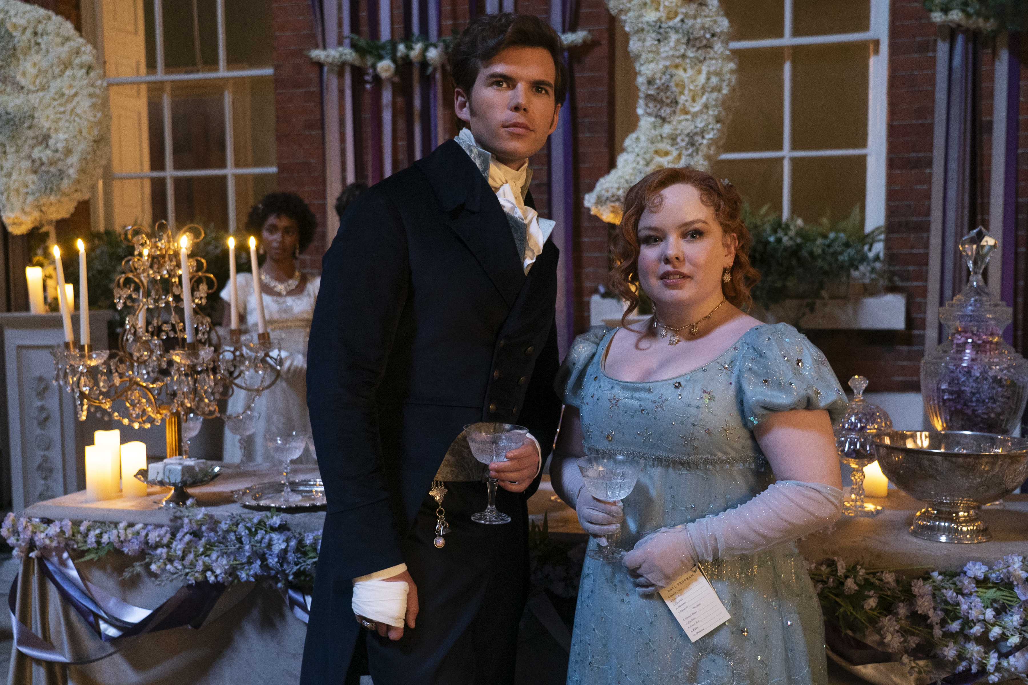 <p>Luke Newton plays Colin Bridgerton and Nicola Coughlan plays Penelope Featherington in episode 2, season 3 of "Bridgerton," which debuts on Netflix on May 16, 2024.</p><p>According to Nicola, the season 3 lead, this next installment has evolved. "I always look at the three seasons like this. I think season 1 was about passion, season 2 was about longing and season 3, I think it's romance all the way," she told People magazine. "It's just so romantic."</p><p>According to the Irish actress, "There were a lot of moments on set where we filmed something and we'd turn around and everyone was sort of clutching their chest being like 'Oh my God.' It was that kind of love."</p>