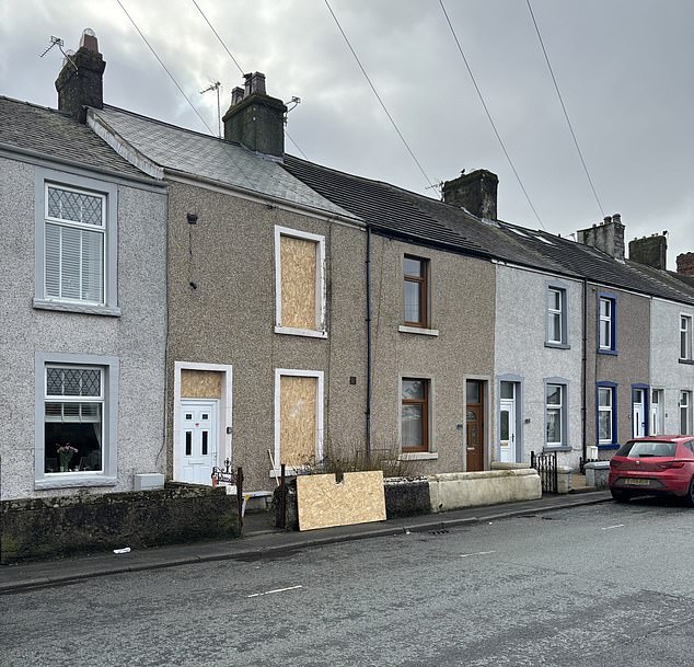victory for cumbrian town in grips of housing crisis as plans to house asylum seekers in eight rundown properties are shelved following furious protest