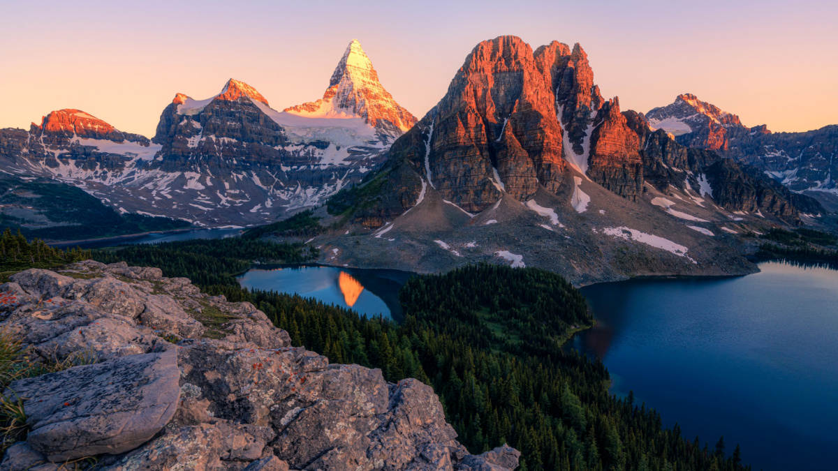 <p>Situated on the border of British Columbia and Alberta, Mount Assiniboine is another glacial horn with steep sides forming a pyramid, so it’s not surprising that it’s often called the “Matterhorn of the Rockies.” One of the best places to view it is from Lake Magog, where it rises 5,000 feet above the waters.</p>