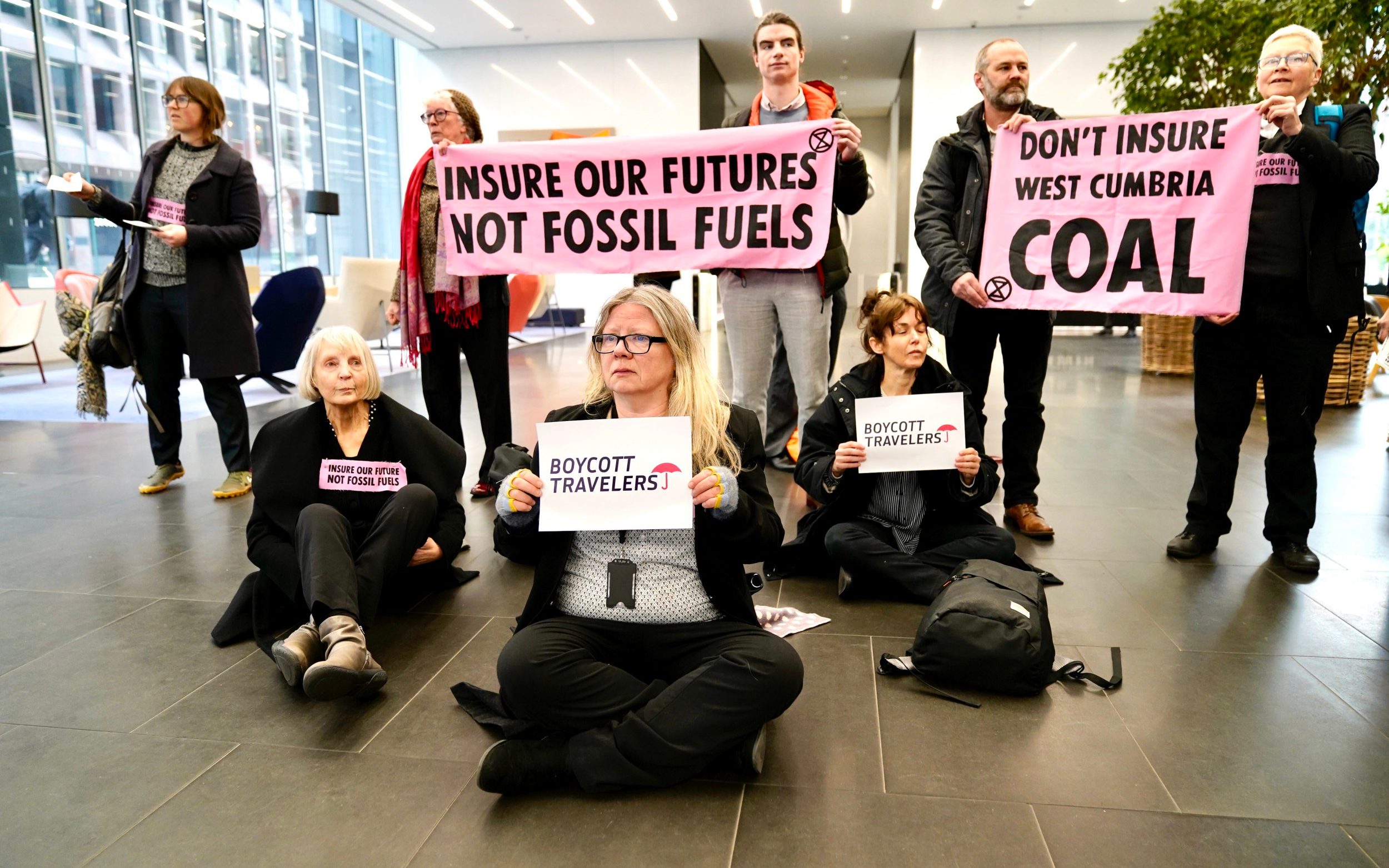 microsoft, extinction rebellion protesters storm walkie talkie dressed in suits