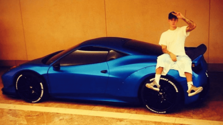 Justin Bieber and his electric blue Ferrari 458 Italia.