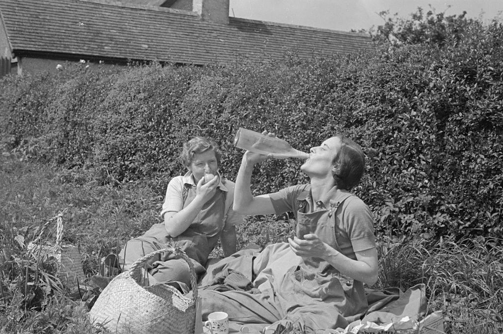 <p>Although when we think of World War II, we usually envision men fighting in both the European and Pacific theaters, women were involved too! Not only were they helping back at home, but some also joined the ranks of the military. </p> <p>Pictured here are two women enjoying a picnic who are serving as members of the Women's Land Army. Mostly, they were made up of domestic servants, shop assistants, housewives, teachers, and other similar jobs at the time. </p>