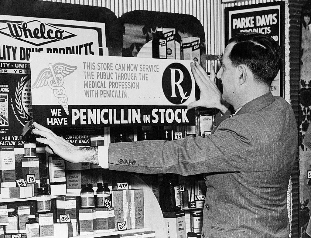 <p>After the discovery and production of penicillin it helped to cure countless people of their ailments. However, during the 1940s, in order to attain it, you still needed a doctor's prescription, and it had to be administered by an actual physician. </p> <p>This picture shows a man putting up a false advertising sign because penicillin was yet to be made available over the counter. We can assume this gentleman made a pretty penny from this lie. </p>