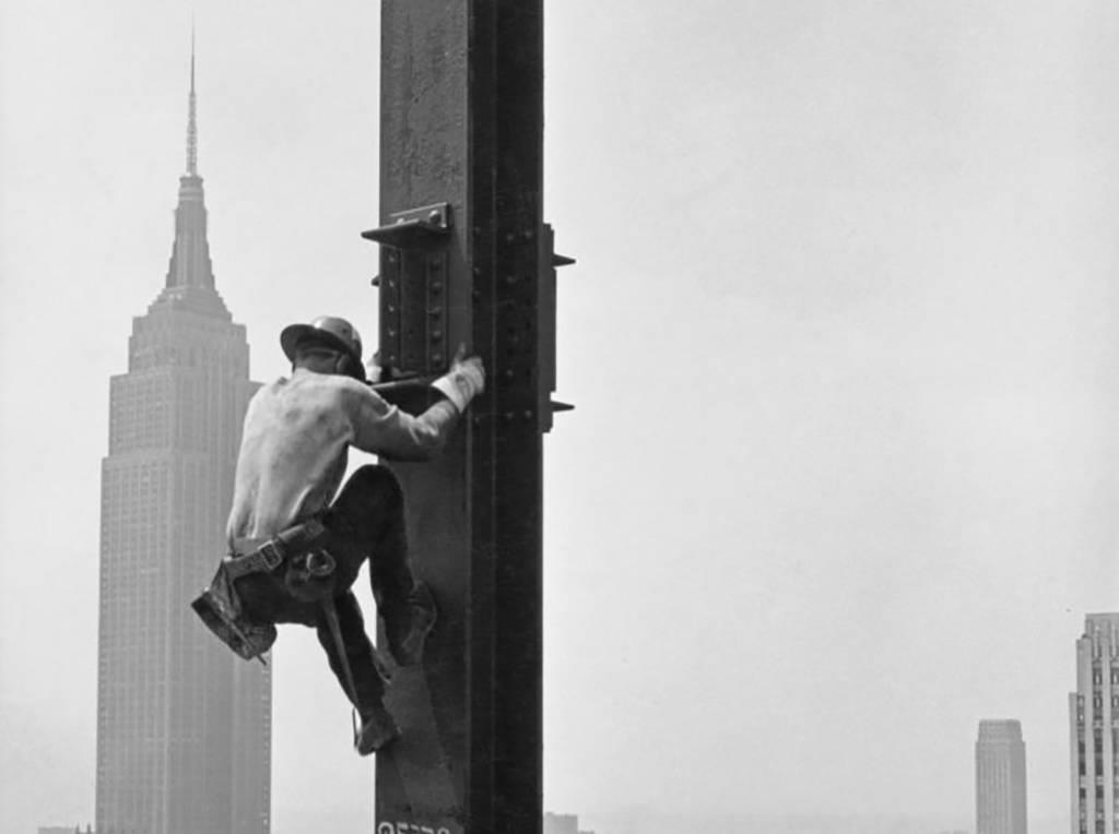 <p>Being a construction worker in New York City during the 1940s certainly had its perks. Here, we see a man scaling a vertical girder with the Empire State Building in the background. </p> <p>Although this worker may have had one of the most breathtaking views of the city at the moment, he probably was more focused on the task at hand. While this may look cool, this man is definitely putting his life on the line performing whatever he is doing. </p>