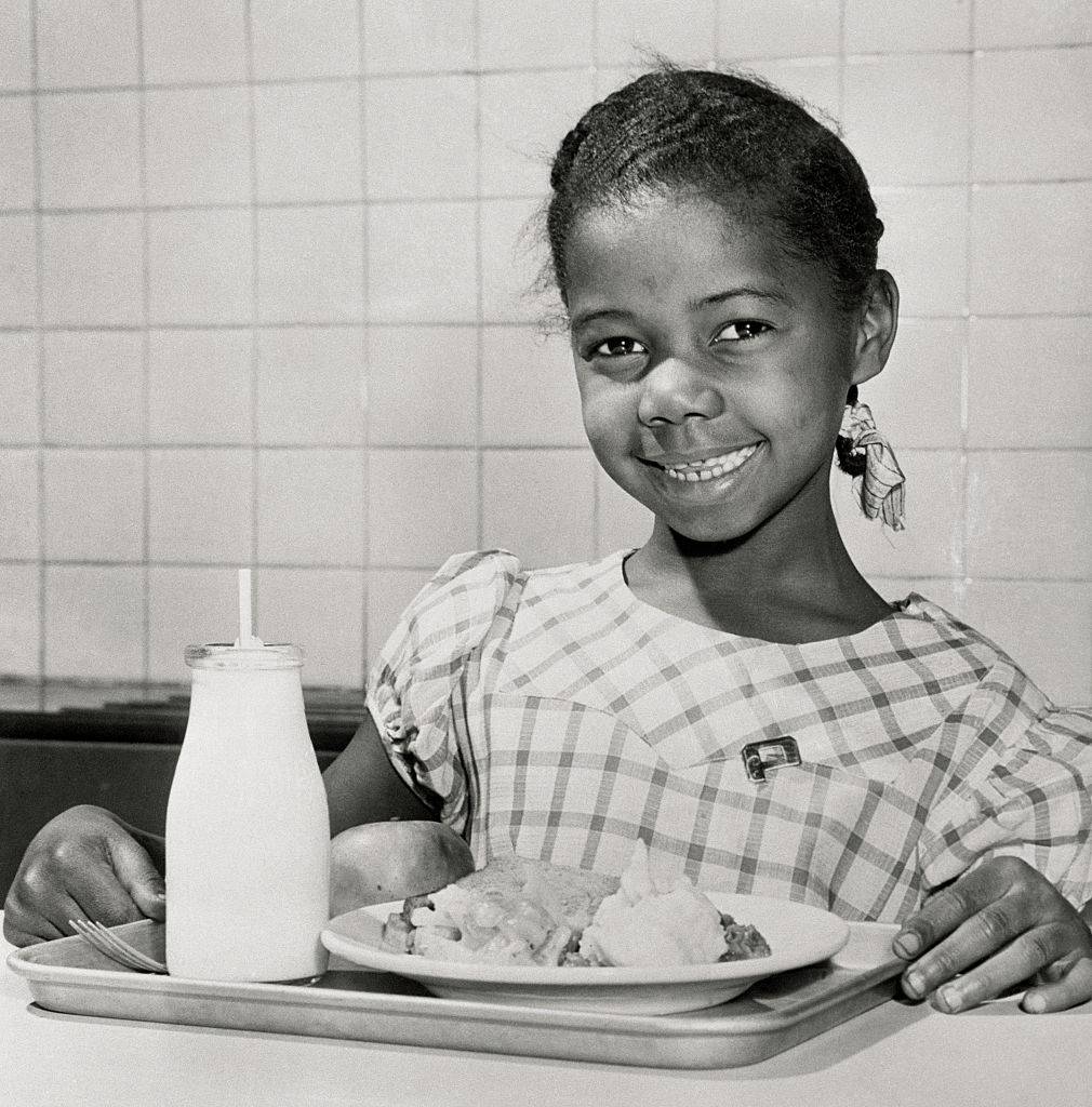 <p>In the 1940s, there was a big surplus of food held by the Department of Agriculture as part of the United State's government's price support program to make sure food didn't go to waste. </p> <p>Here, a young student is showing off her full plate of food, specifically potatoes that her school received during the surplus. This was toward the end of the decade when all of the efforts were no longer going towards the war. </p>