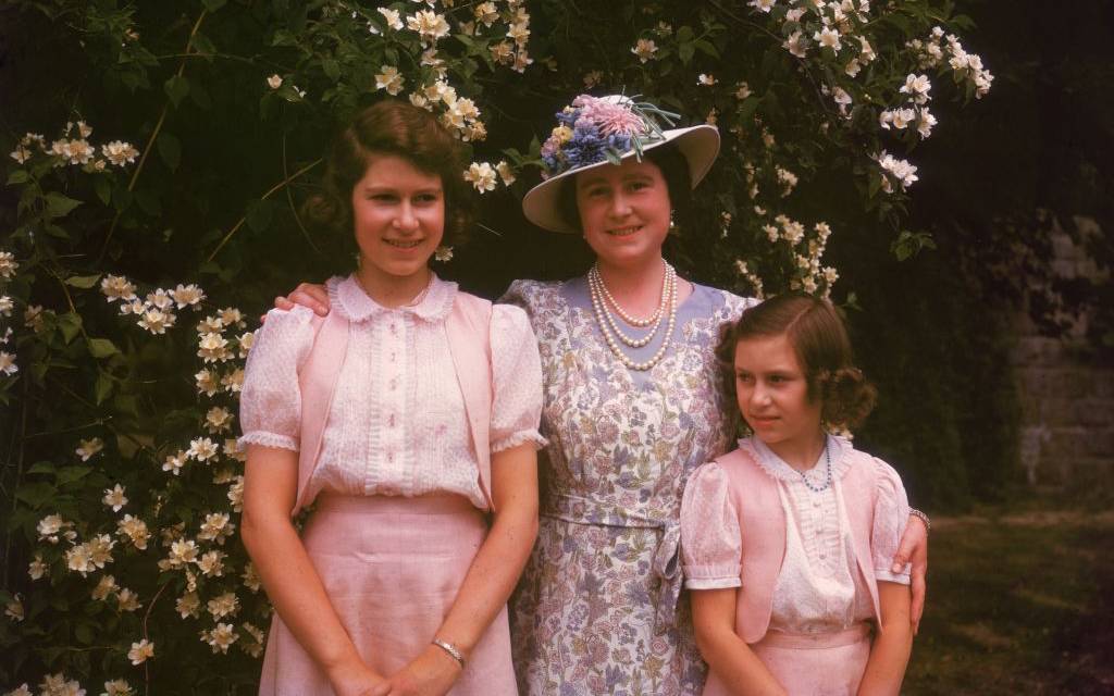 <p>Featured in this photograph is the original Queen Elizabeth and her two daughters, Princesses Elizabeth and Margaret, on the grounds of Windsor Castle. </p> <p>Little does Elizabeth know just what an extensive reign her future held! Even at a glance, we can tell this is Elizabeth!</p>