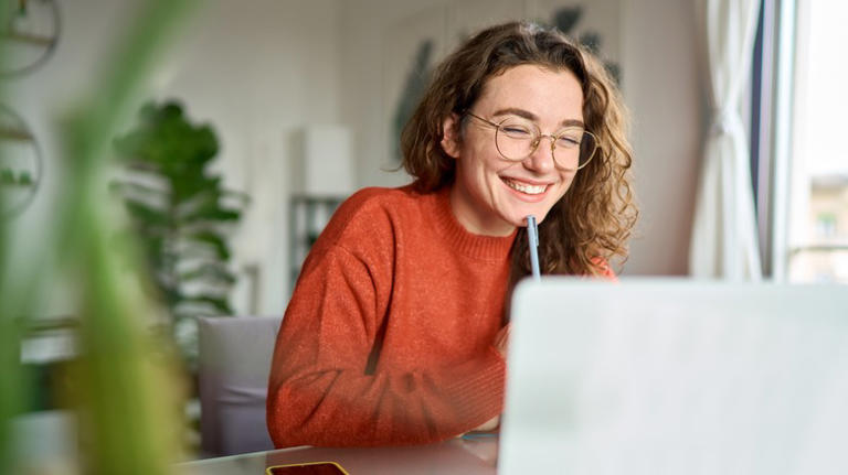 Woman smiling at laptop 