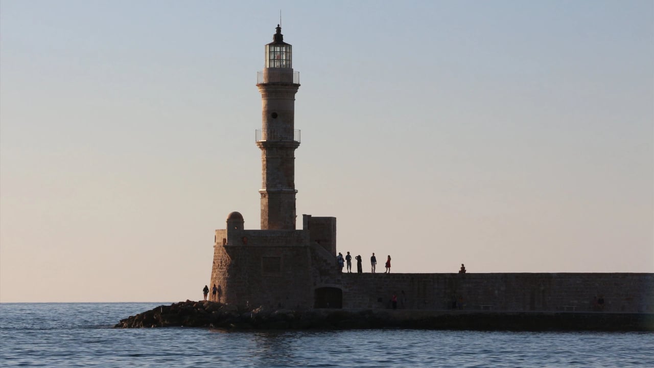 <p>Chania Port is an old Venetian Port on Crete. It is considered one of the prettiest locations on the island, and it’s a great place to sip wine while the sun goes down after a long day of swimming. Cheers!</p>