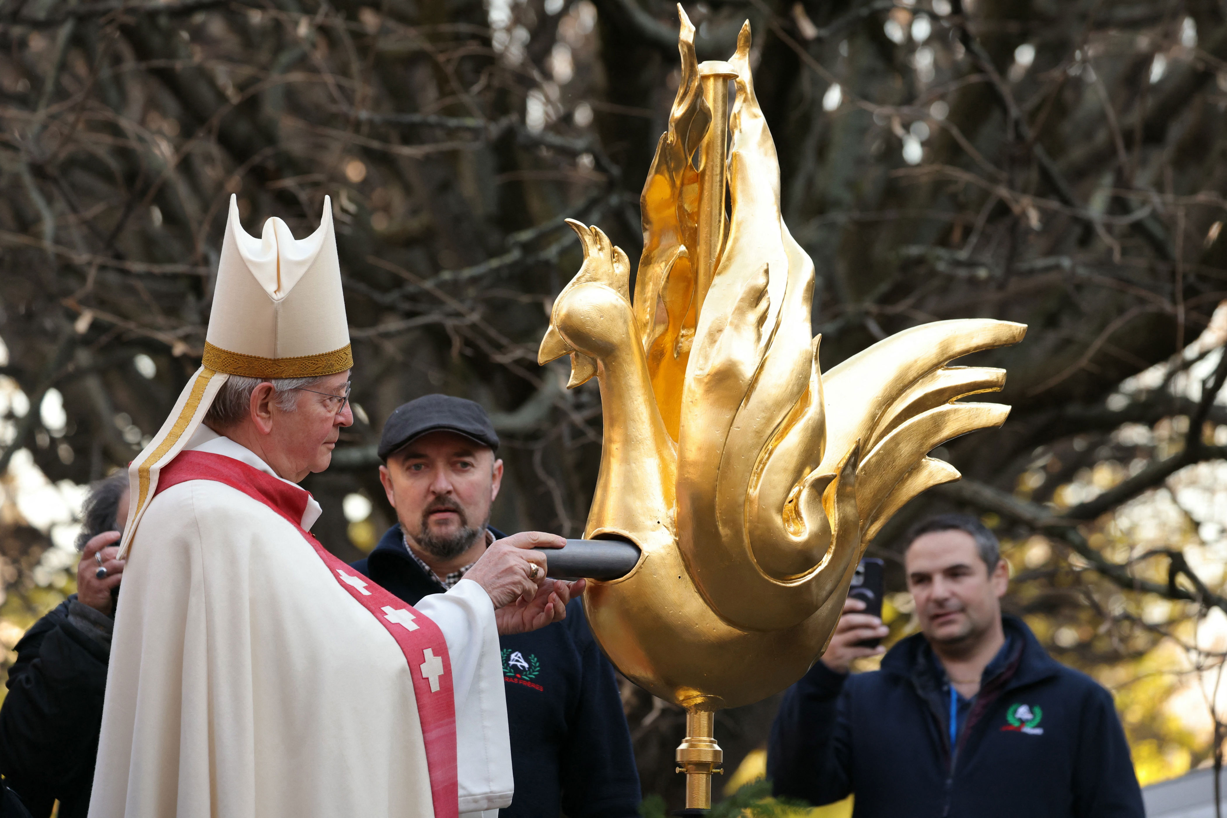 notre dame’s new spire unveiled after 2019 fire, complete with golden rooster