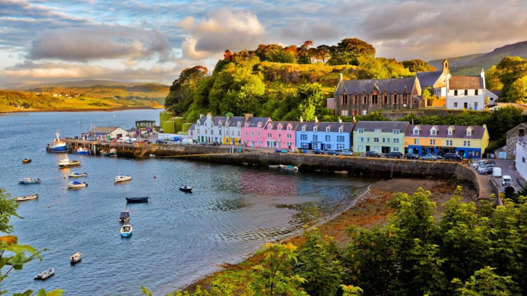 <p><span>The colorful town of Portree is an excellent home base for your trip to the island. Although small, it’s the island’s capital, so plenty of amenities exist, including shops, cafes, and accommodations. It’s also a great place to pick up a souvenir or two.</span></p><p><span>The town’s location is beautiful, as lush green hills, the Sound of Raasay, and Loch Portree surround the town. If you have a car, you’ll also have easy access to some of the island’s main attractions.</span></p>