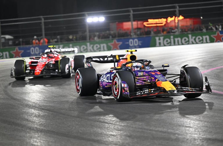 Sergio Perez of Oracle Red Bull Racing, right, and Charles Leclerc of the Scuderia Ferrari team compete in the Las Vegas Grand Prix on Nov. 19, 2023.