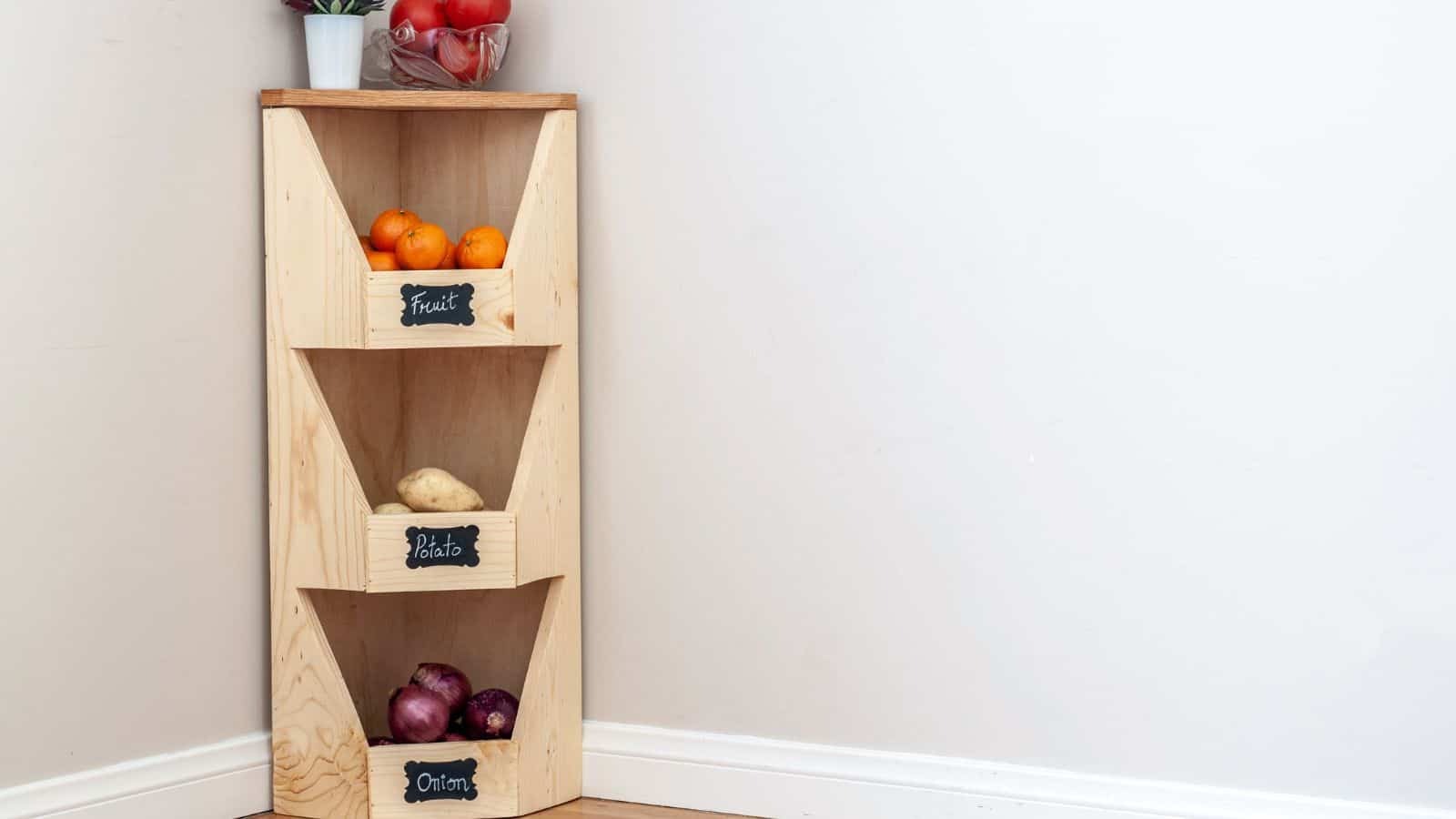 <p>Anything that helps with kitchen organization is a win. Get your kitchen organized with this easy beginner woodworking project. This DIY corner vegetable bin is great for root vegetables and even fruit. It fits in any corner, and it looks great too! <a href="https://www.anikasdiylife.com/diy-corner-vegetable-storage-bin/">See how to build it here.</a></p>