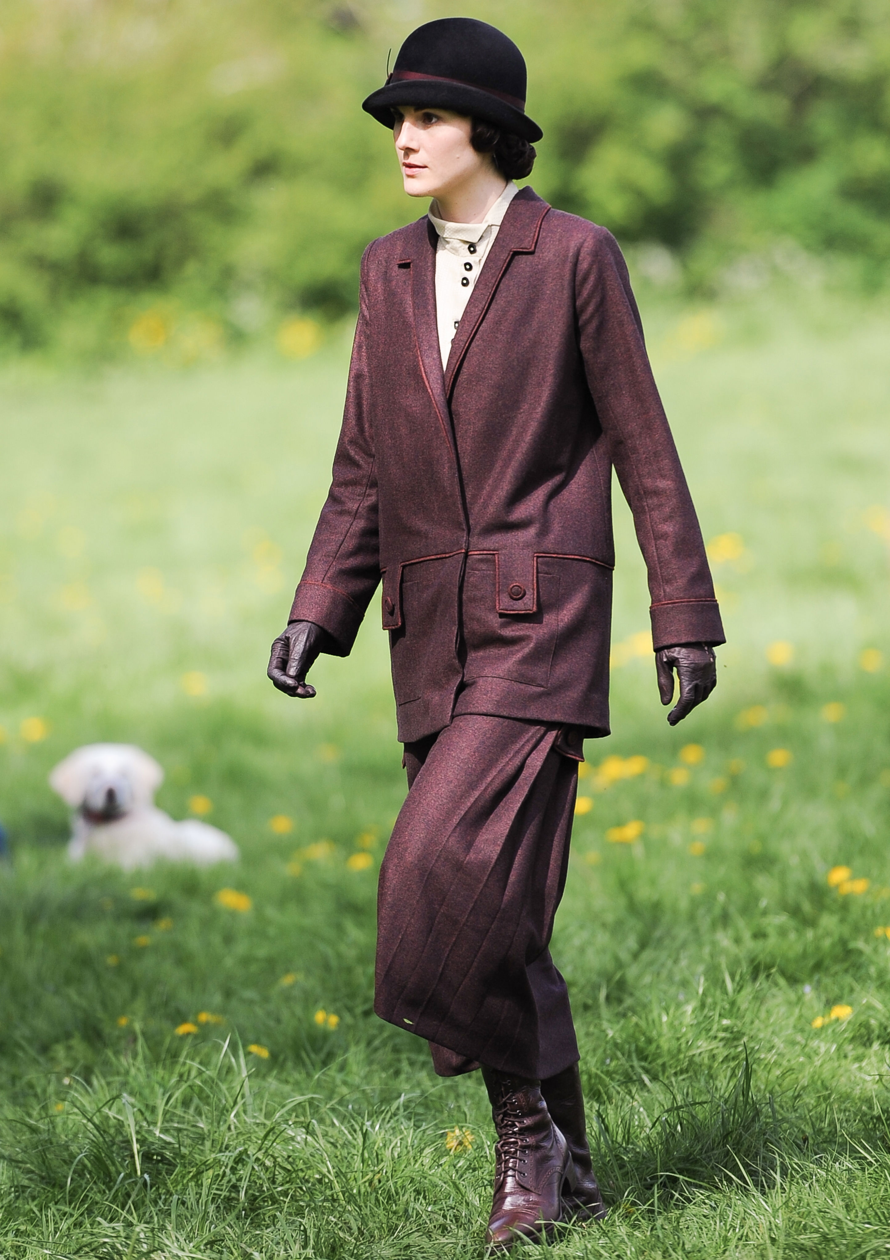 <p><a href="https://www.wonderwall.com/celebrity/profiles/overview/michelle-dockery-1488.article">Michelle Dockery</a> is seen here filming season 5 of "Downton Abbey" in Oxfordshire, England, in 2014 wearing a rich merlot suit with a matching hat, boots and gloves. "Her wardrobe is quite linear and androgynous. I studied lots of fashion plates and men's tailoring from the period, which inspired some of the more structured outfits she wears when she's running the estate," costume designer Anna Mary Scott Robbins told <a href="https://www.vogue.co.uk/article/downton-abbey-film-costumes-anna-jones-interview">Vogue</a>. "She's a girl in a man's world, but she's doing it her way. Her color scheme tends to be quite bold -- deep burgundies and navy blues that would never suit the other characters."</p>