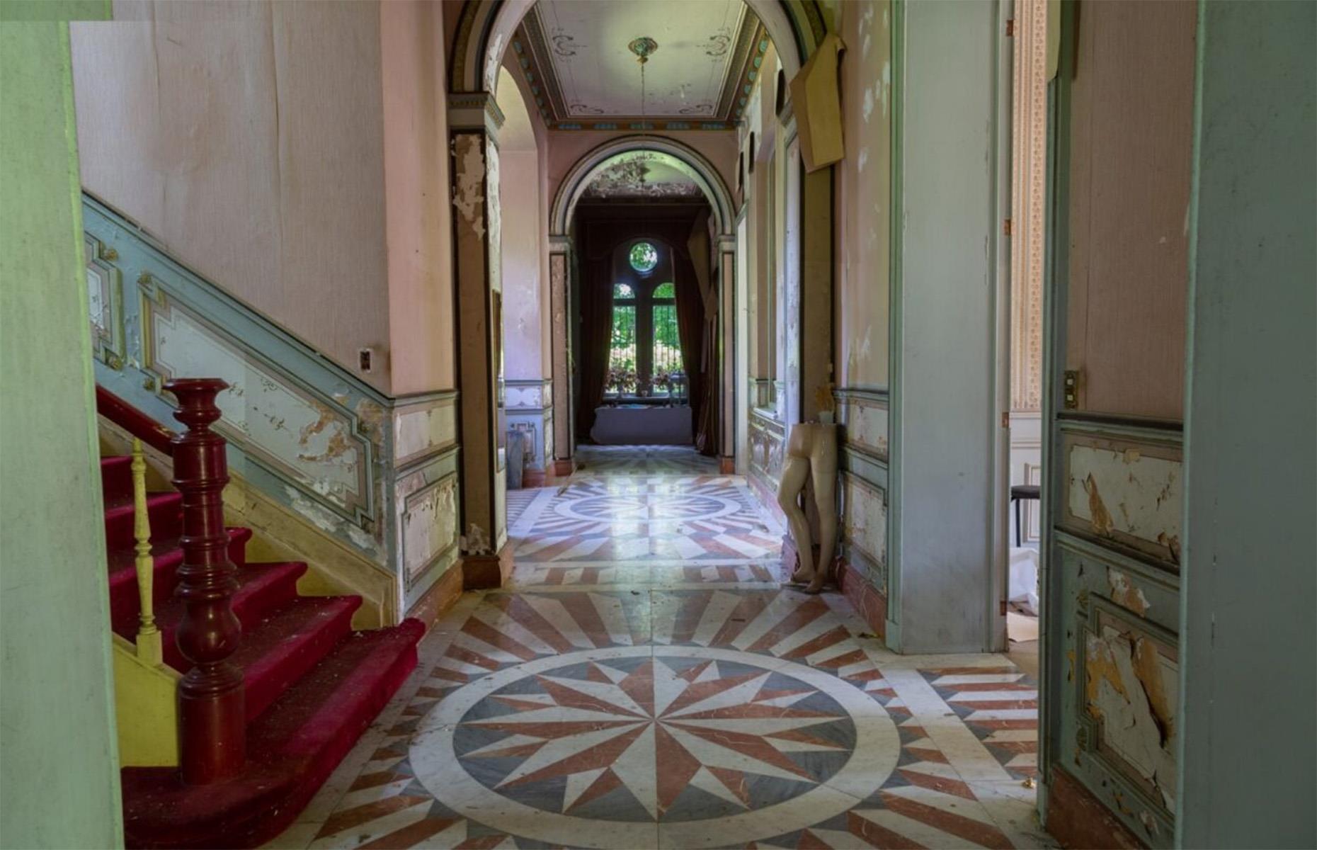 <p>Though in desperate need of restoration, the home still boasts gorgeous architectural features, including marble floors, tapestried walls, crystal chandeliers, leaded stained-glass windows, and exquisitely painted ceilings. </p>