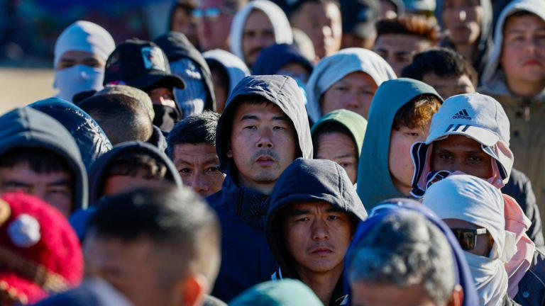 Migrants are seen in line in Jacumba, California, as border authorities are contending with an influx of Chinese migrants in a key border sector. Getty Images